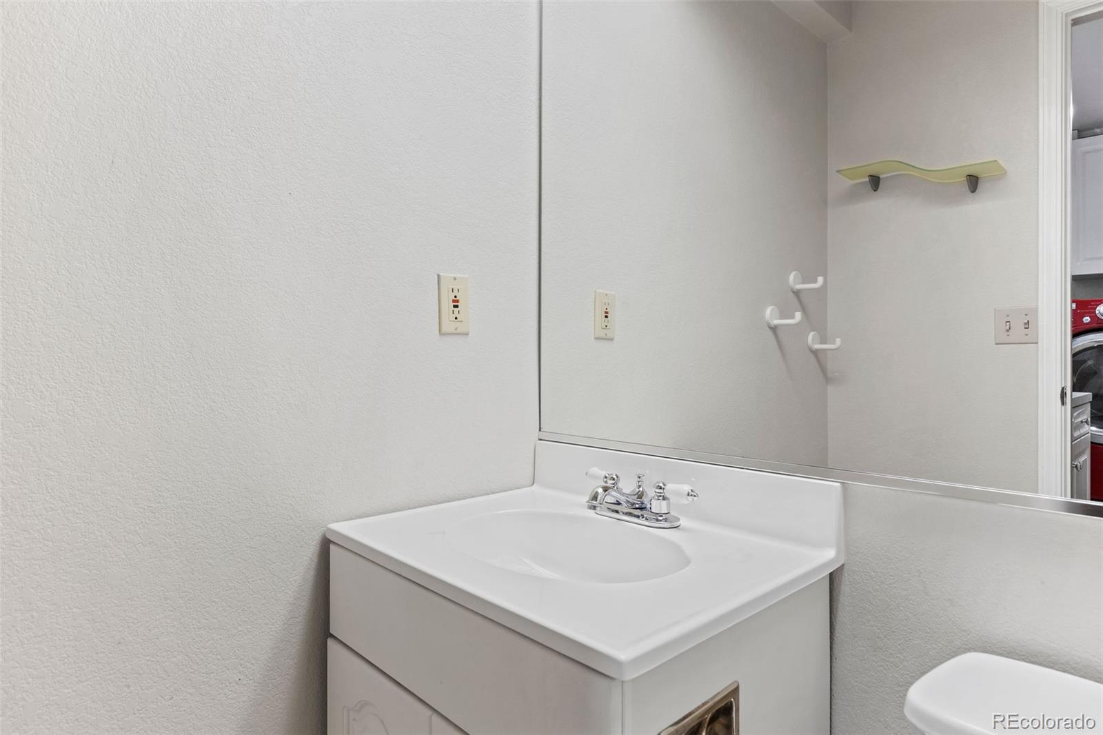 8536 Union Circle Arvada, CO 80005 - Photo 25 of 26 a bathroom with a sink toilet and vanity