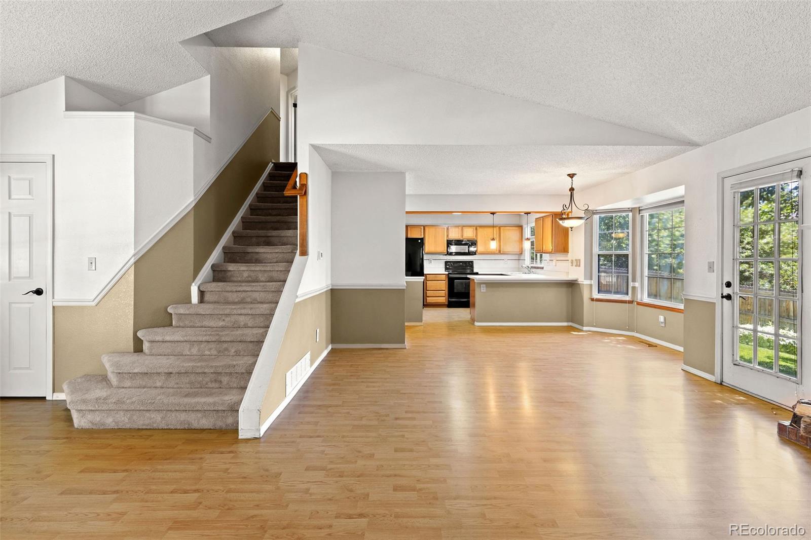 8536 Union Circle Arvada, CO 80005 - Photo 4 of 26 a view of an empty room with kitchen view and living room