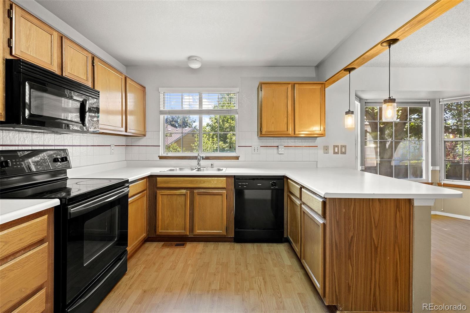 8536 Union Circle Arvada, CO 80005 - Photo 10 of 26 a kitchen with stainless steel appliances granite countertop a sink stove and refrigerator
