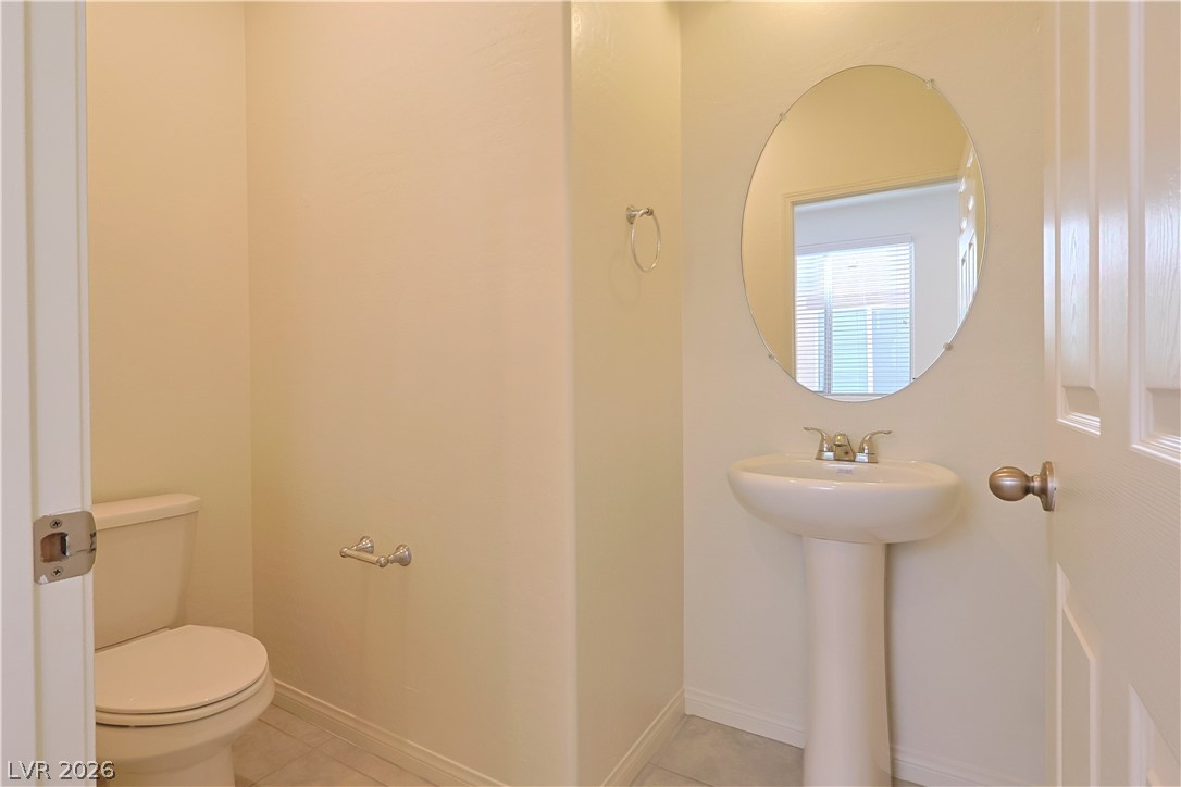 8663 Reynolds Spring Street Las Vegas, NV 89178 - Photo 13 of 32 A classic pedestal sink and clean tile flooring define this charming powder room.