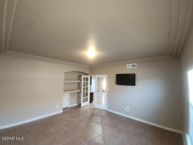 3225 Ivy Point Way El Paso, TX 79938 - Photo 13 of 35 a view of a livingroom with a flat screen tv and refrigerator