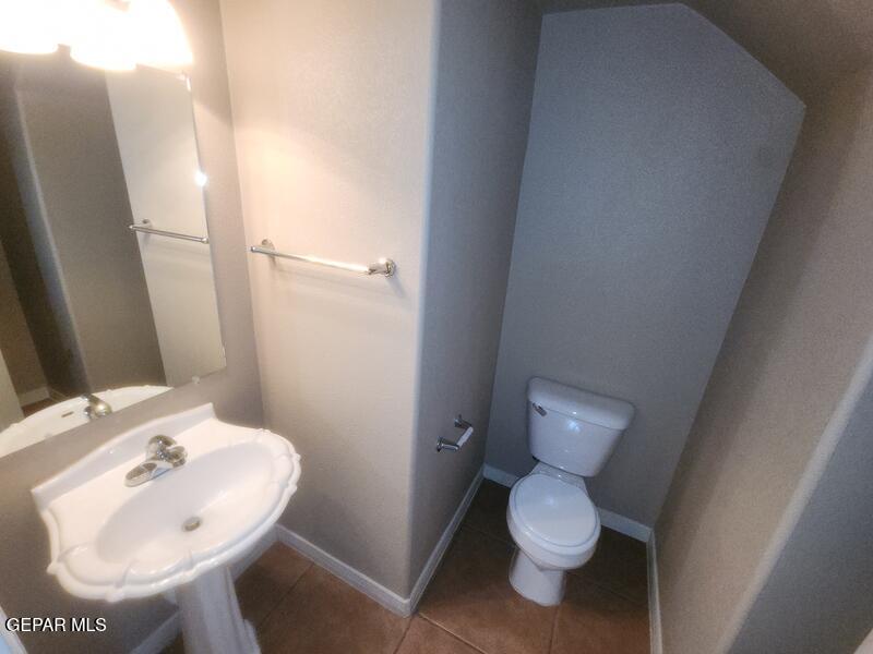 3225 Ivy Point Way El Paso, TX 79938 - Photo 14 of 35 a bathroom with a toilet sink and a mirror