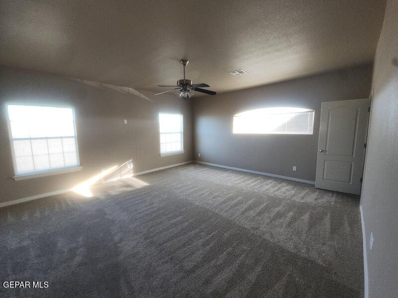 3225 Ivy Point Way El Paso, TX 79938 - Photo 18 of 35 an empty room with windows and fan