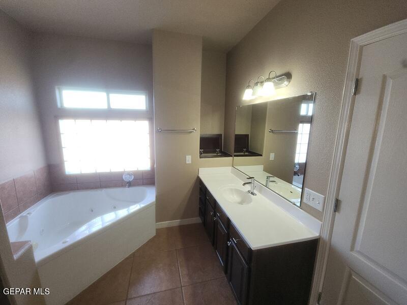 3225 Ivy Point Way El Paso, TX 79938 - Photo 20 of 35 a bathroom with a tub sink and mirror