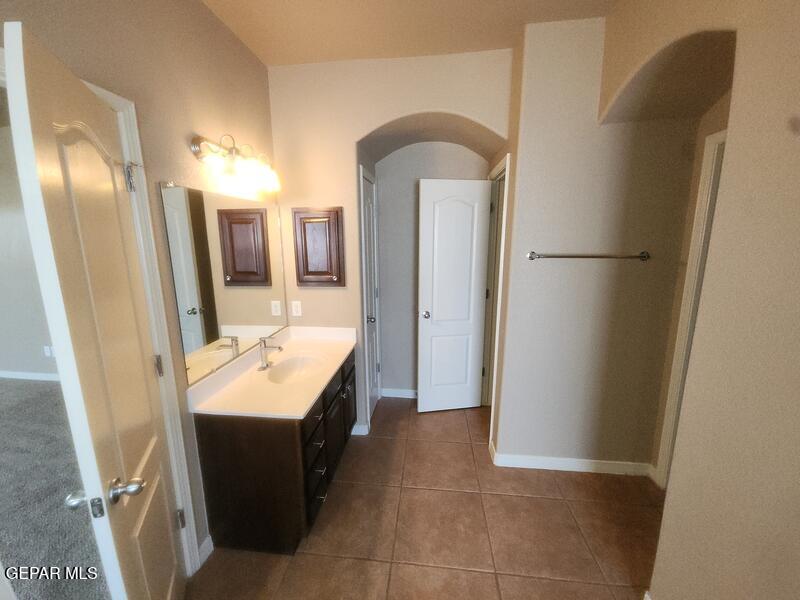 3225 Ivy Point Way El Paso, TX 79938 - Photo 21 of 35 a en suite bathroom with a sink a mirror and a shower