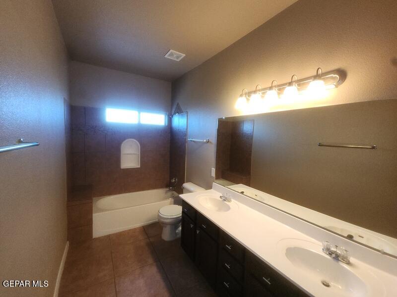 3225 Ivy Point Way El Paso, TX 79938 - Photo 23 of 35 a bathroom with a sink double vanity granite tub and shower