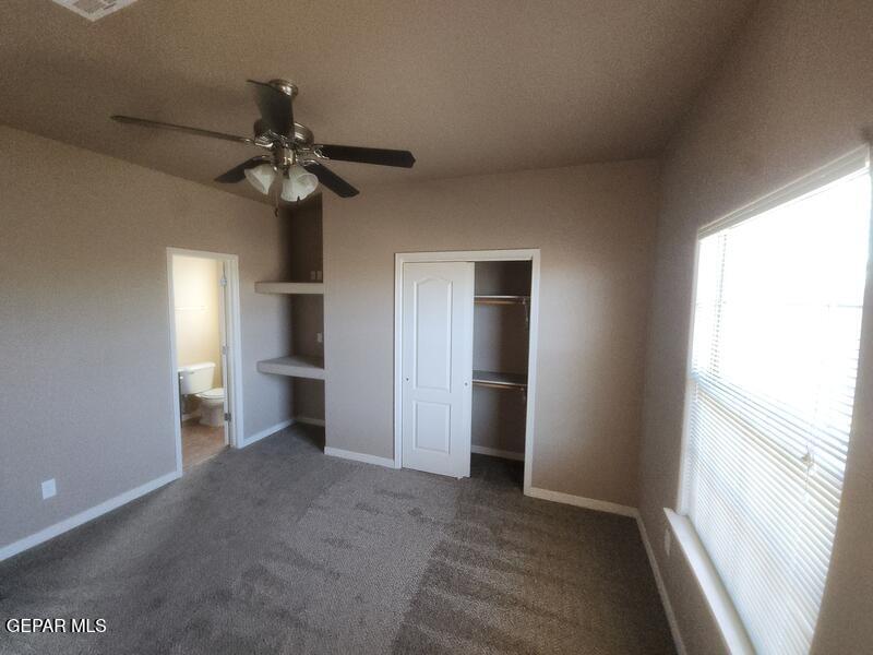 3225 Ivy Point Way El Paso, TX 79938 - Photo 25 of 35 a view of a room with a ceiling fan and a window
