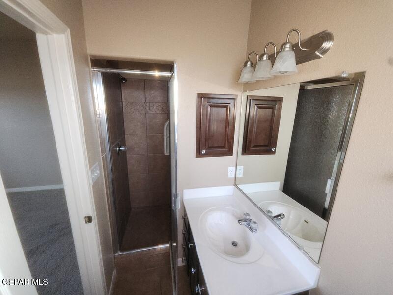 3225 Ivy Point Way El Paso, TX 79938 - Photo 26 of 35 a bathroom with a sink and mirror