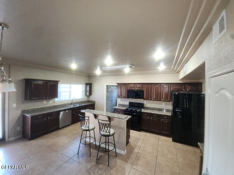 3225 Ivy Point Way El Paso, TX 79938 - Photo 7 of 35 a kitchen with cabinets a sink and a counter top space