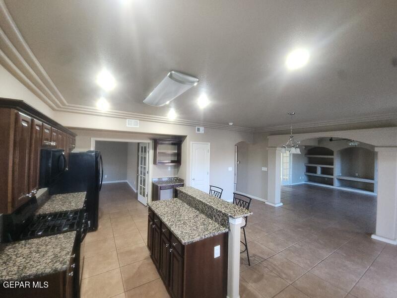 3225 Ivy Point Way El Paso, TX 79938 - Photo 8 of 35 a kitchen with kitchen island a counter top space a sink stainless steel appliances and cabinets