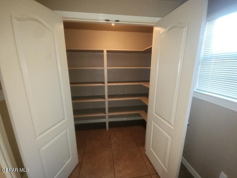 3225 Ivy Point Way El Paso, TX 79938 - Photo 9 of 35 a view of walk in closet with empty racks