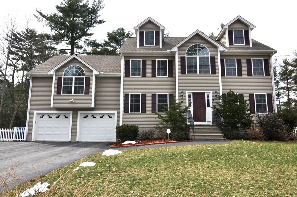 6 Dell Hollow Road Billerica, MA 01821 - Photo 1 of 25 a front view of a house with a yard and garage