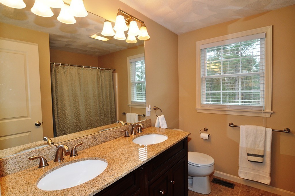 6 Dell Hollow Road Billerica, MA 01821 - Photo 14 of 25 a bathroom with a granite countertop sink and a mirror