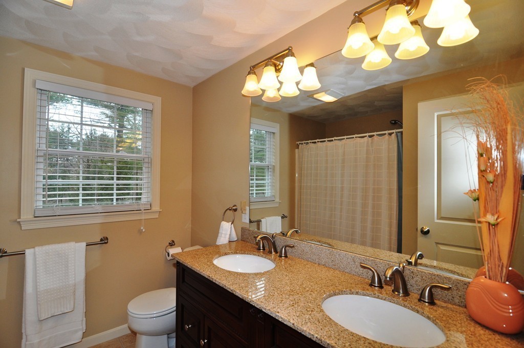 6 Dell Hollow Road Billerica, MA 01821 - Photo 15 of 25 a bathroom with a granite countertop sink a large mirror and a toilet
