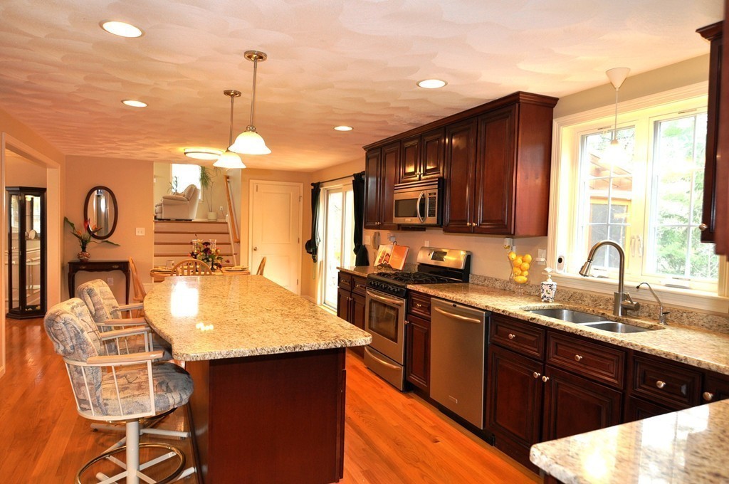 6 Dell Hollow Road Billerica, MA 01821 - Photo 7 of 25 a kitchen with granite countertop a sink cabinets and stainless steel appliances