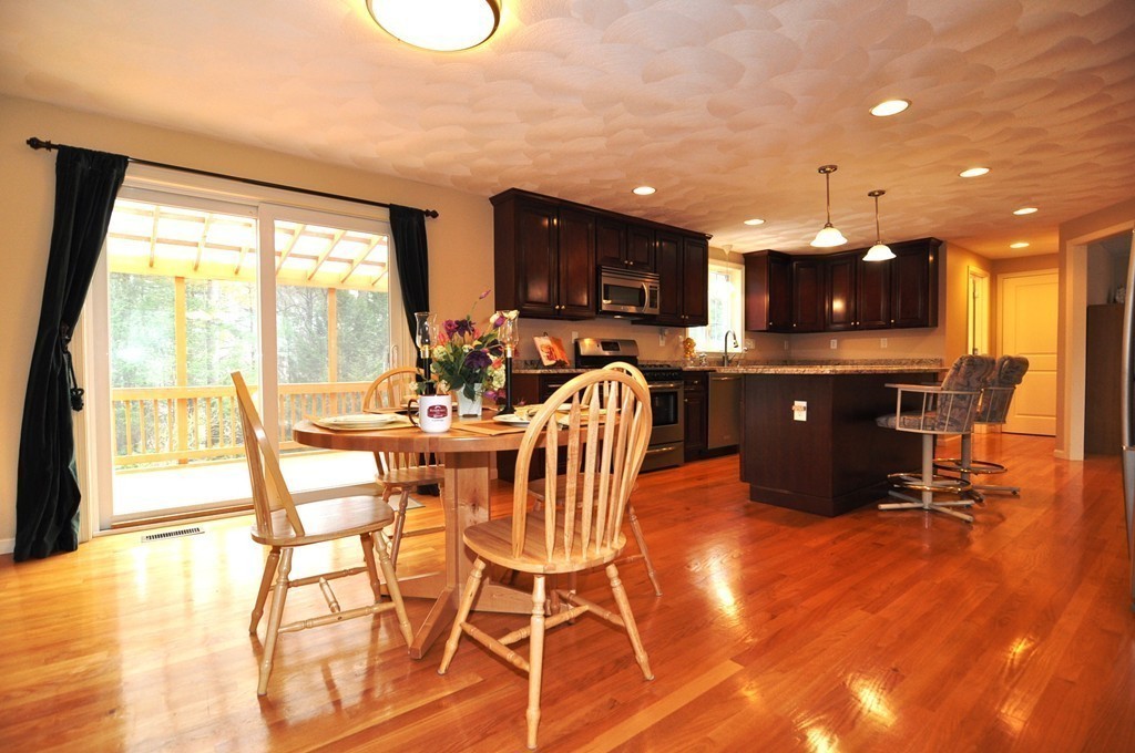 6 Dell Hollow Road Billerica, MA 01821 - Photo 8 of 25 a view of a dining room with furniture a chandelier and wooden floor