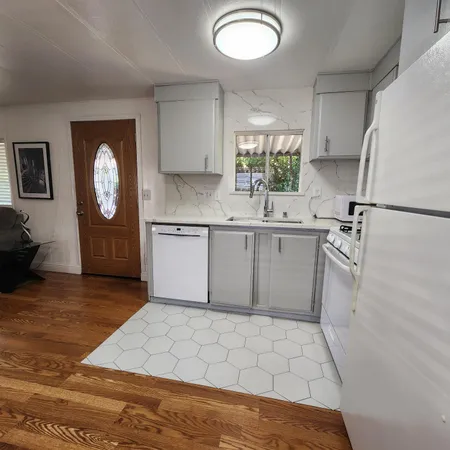 a kitchen with a sink a stove and cabinets