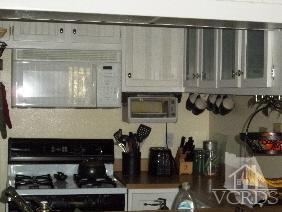 1724 Sinaloa Road, Unit 225 Simi Valley, CA 93065 - Photo 3 of 9 a kitchen with a stove and cabinets