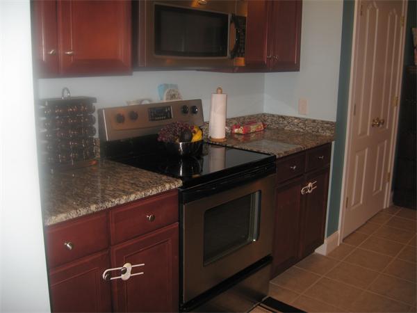 46 Daniels Road Charlton, MA 01507 - Photo 14 of 30 a kitchen with granite countertop a stove and a sink
