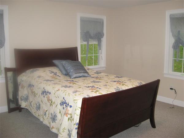46 Daniels Road Charlton, MA 01507 - Photo 19 of 30 a bed sitting in a bedroom next to a window