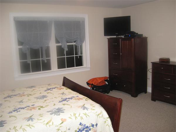 46 Daniels Road Charlton, MA 01507 - Photo 21 of 30 a bedroom with a bed and flat screen tv