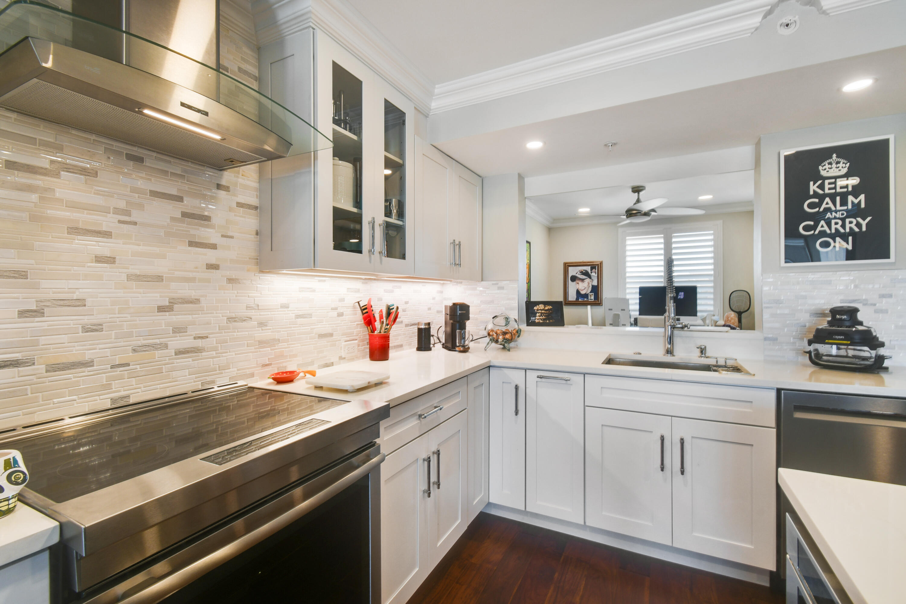 2401 Marina Isle Way, Unit 503 Jupiter, FL 33477 - Photo 9 of 46 a kitchen with a sink stove and cabinets