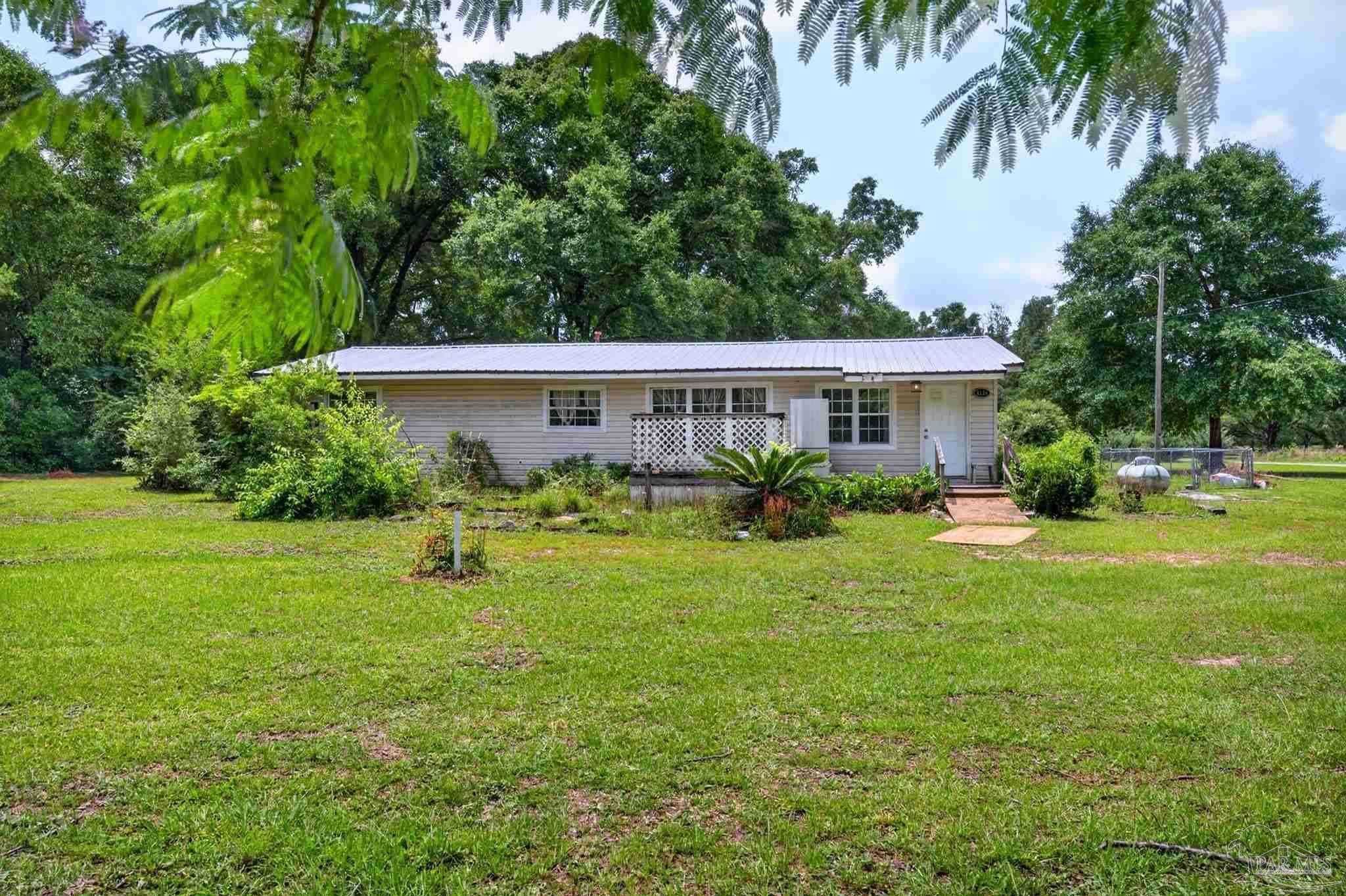 6253 Allentown Road Milton, FL 32570 - Photo 1 of 31 a view of a house with a yard and sitting area
