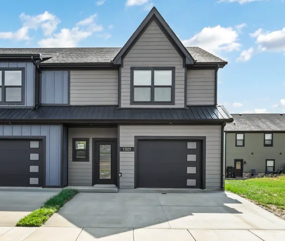 a front view of a house with a garden and garage