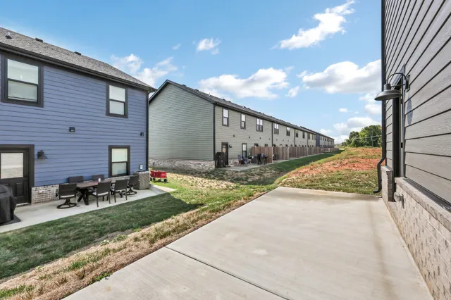 a view of backyard of house and car parked