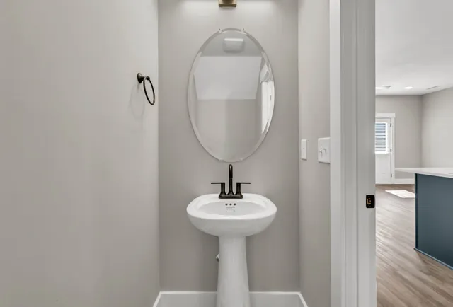 a bathroom with a sink a mirror and a shower