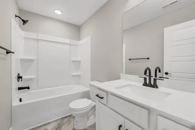 a bathroom with a sink a toilet and a bathtub