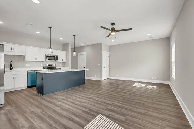 a large kitchen with stainless steel appliances kitchen island a refrigerator sink and cabinets