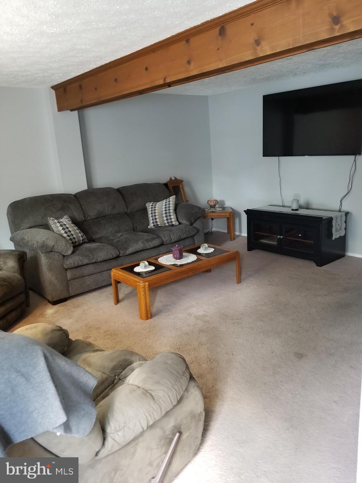 1774 Springfield Lane Frederick, MD 21702 - Photo 2 of 18 Lovely large living room with wood beam.