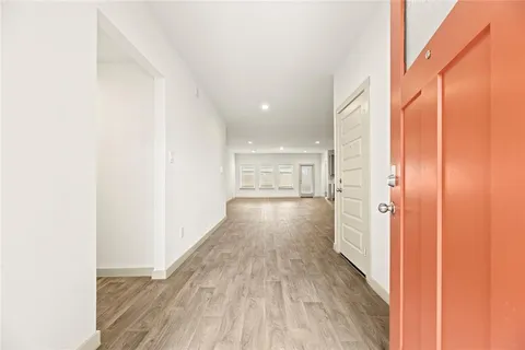 a view of a hallway with wooden floor