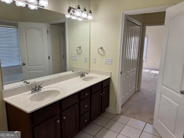 a bathroom with a sink vanity and a mirror
