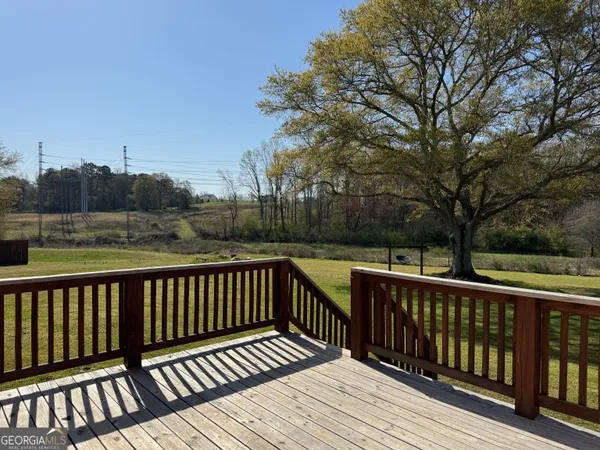 a view of balcony with wooden floor and fence