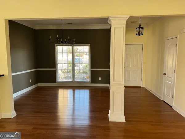 a view of a black door and wooden floor