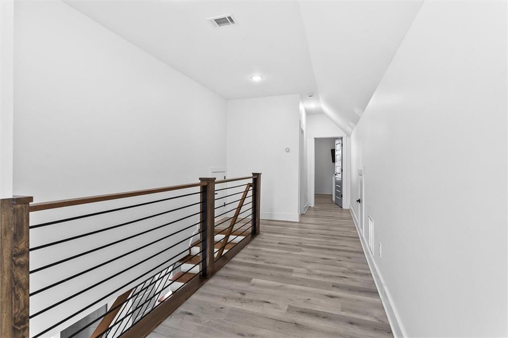 658 Rockbridge Road Northwest Lilburn, GA 30047 - Photo 10 of 61 a view of a hallway with wooden floor and staircase
