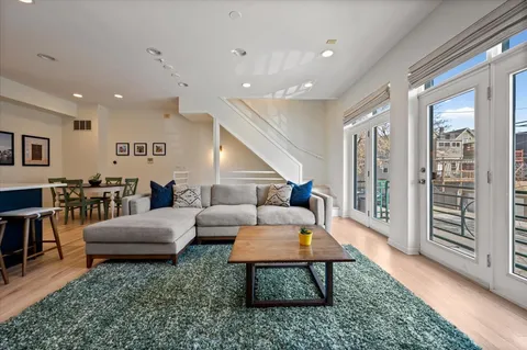 a bedroom with a bed and dresser with mirror