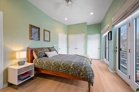 a bedroom with a bed and a chandelier