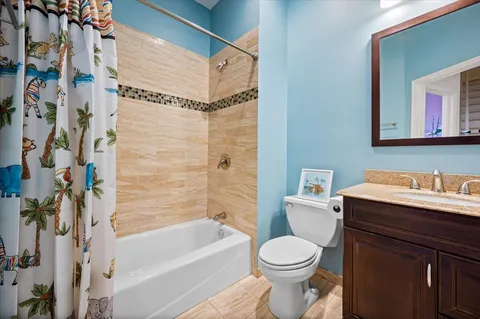 a view of a hallway with a livingroom and a bathroom