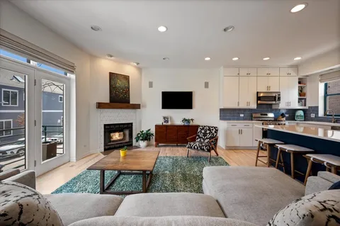 a living room with furniture a flat screen tv and a fireplace