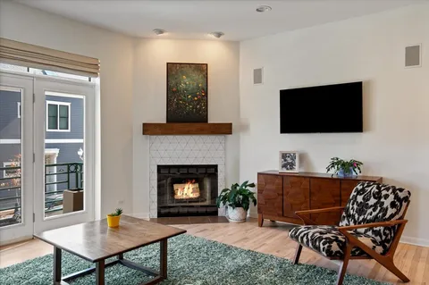 a living room with fireplace furniture and a flat screen tv