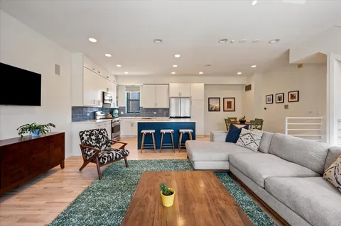 a kitchen with stainless steel appliances granite countertop a refrigerator stove microwave and sink