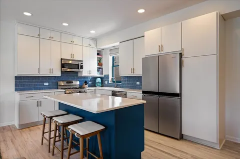 a kitchen with a sink a stove and cabinets