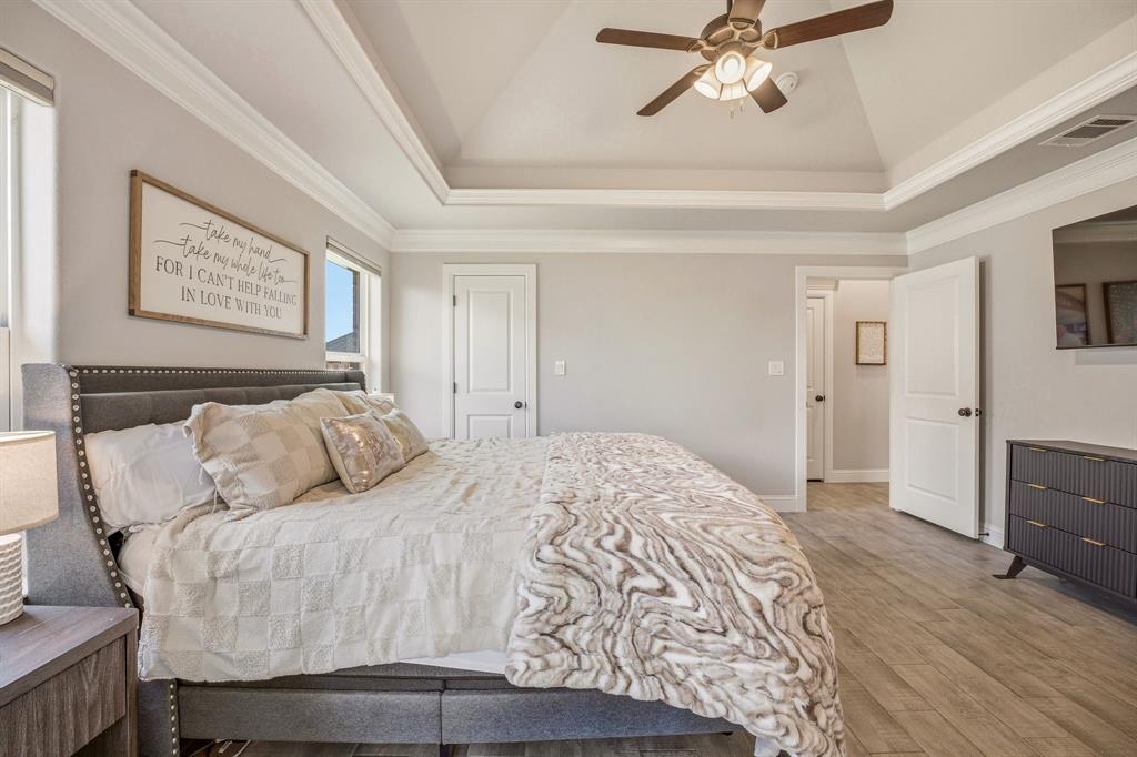 601 Violet Tolar, TX 76476 - Photo 12 of 26 a bedroom with a bed and a chandelier