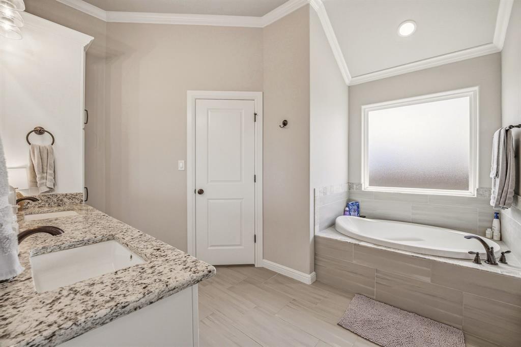 601 Violet Tolar, TX 76476 - Photo 13 of 26 a bathroom with a granite countertop tub sink and mirror