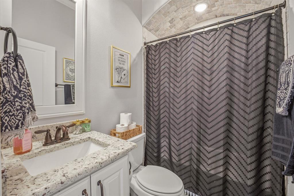601 Violet Tolar, TX 76476 - Photo 17 of 26 a bathroom with a granite countertop sink mirror vanity and toilet