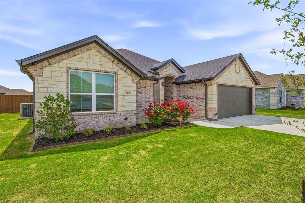 601 Violet Tolar, TX 76476 - Photo 22 of 26 a front view of a house with a yard and garage