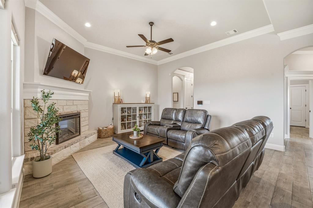 601 Violet Tolar, TX 76476 - Photo 4 of 26 a living room with furniture a fireplace and a flat screen tv